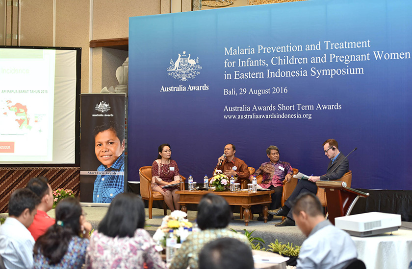 A speakers are sitting on the stage